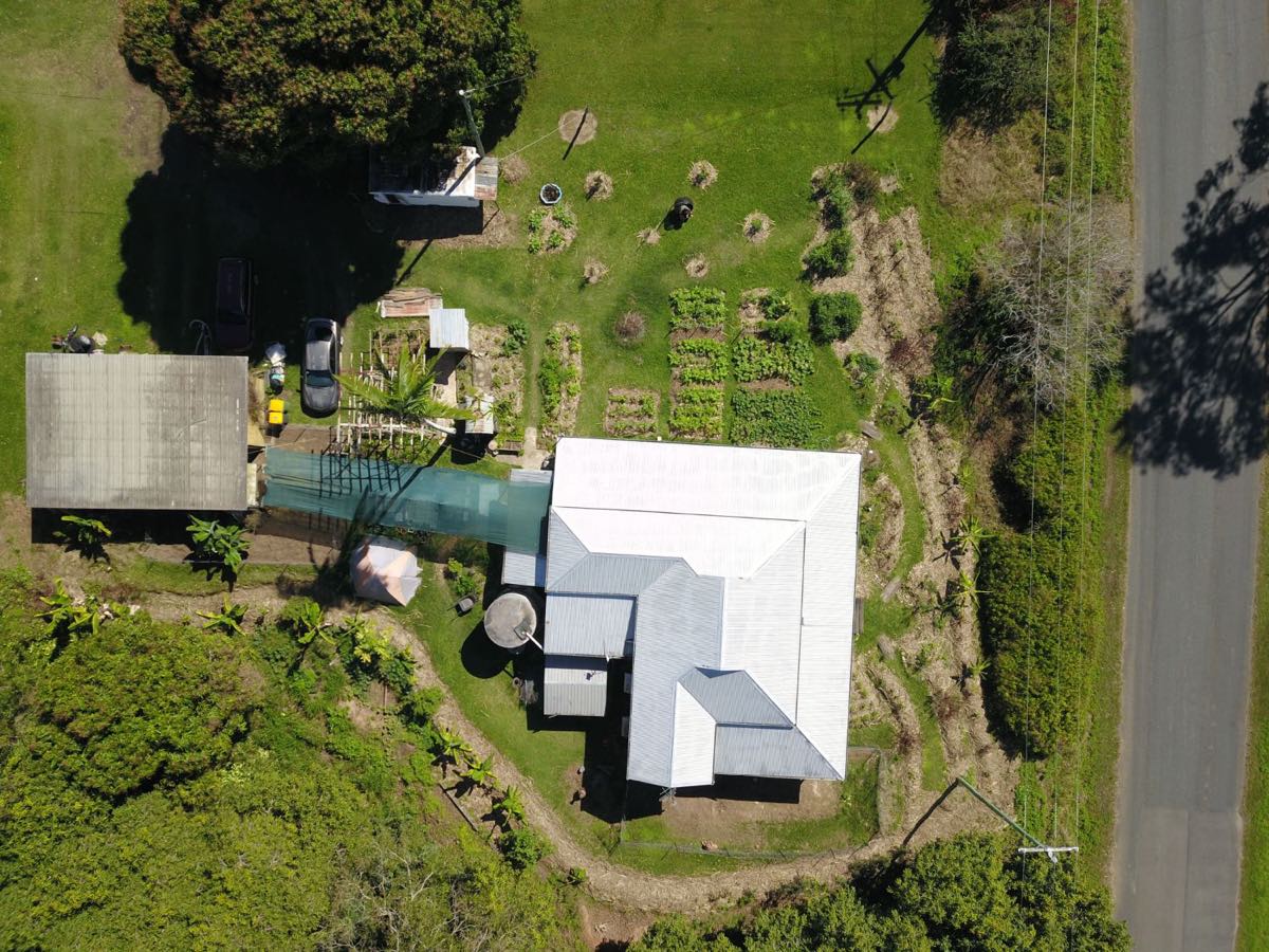 Aerial view of the Calen house, market garden beds and surrounding bananas